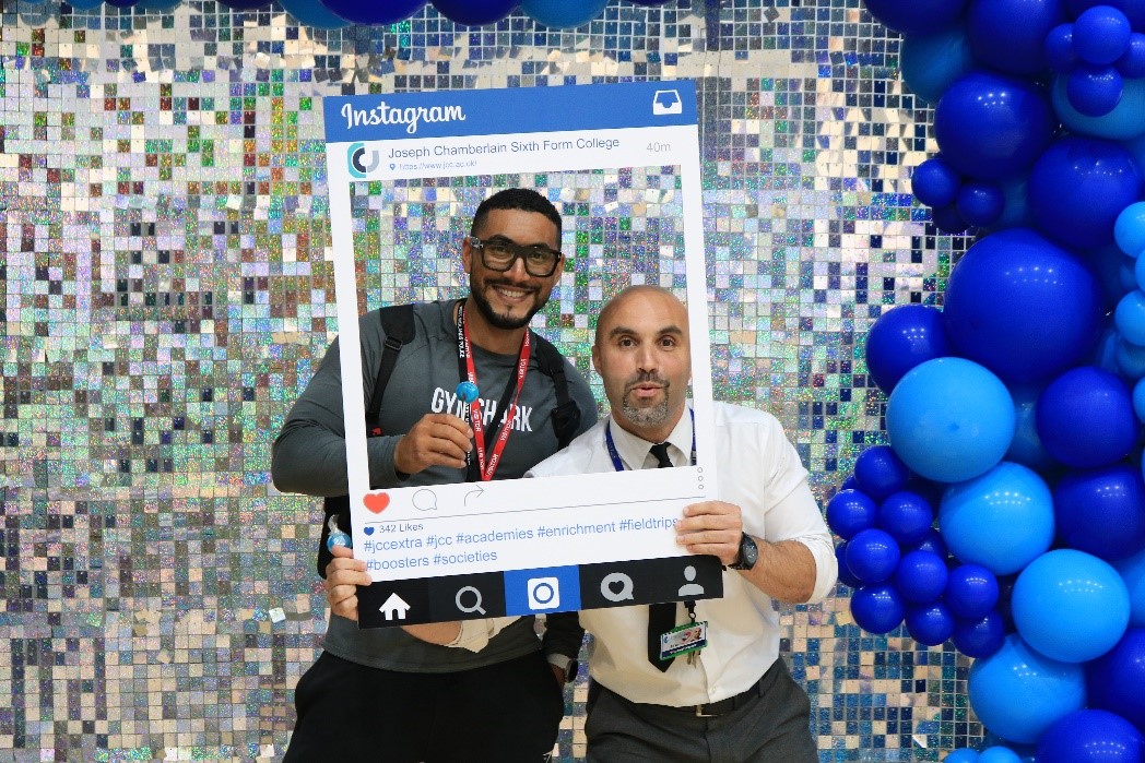Picture of a member of staff and a visitor at the selfie booth from Joseph Chamberlain College's JCC Extra Freshers' Fair. This is being used for decorative purposes.